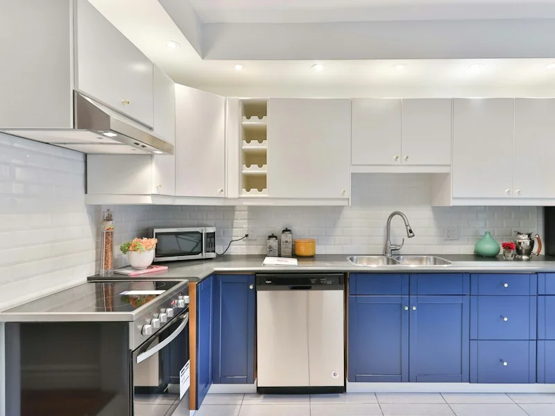 Kitchen with painted blue lower cabinets