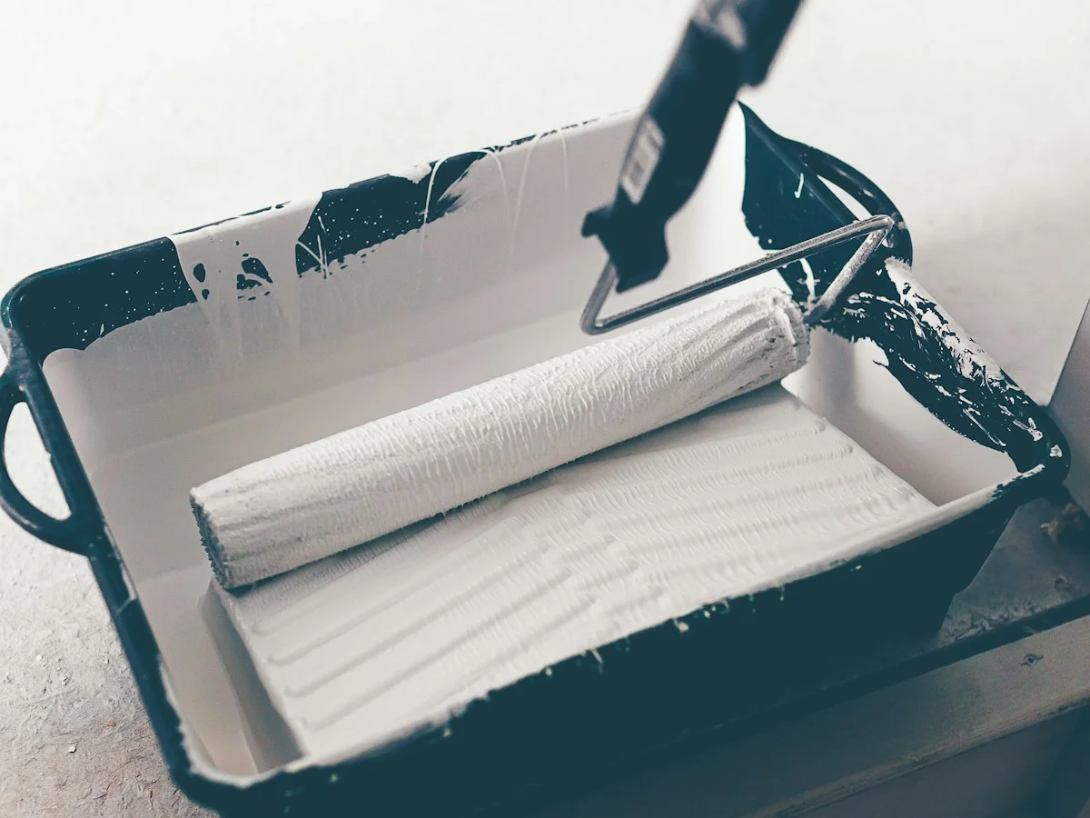 Paint roller resting in a paint tray
